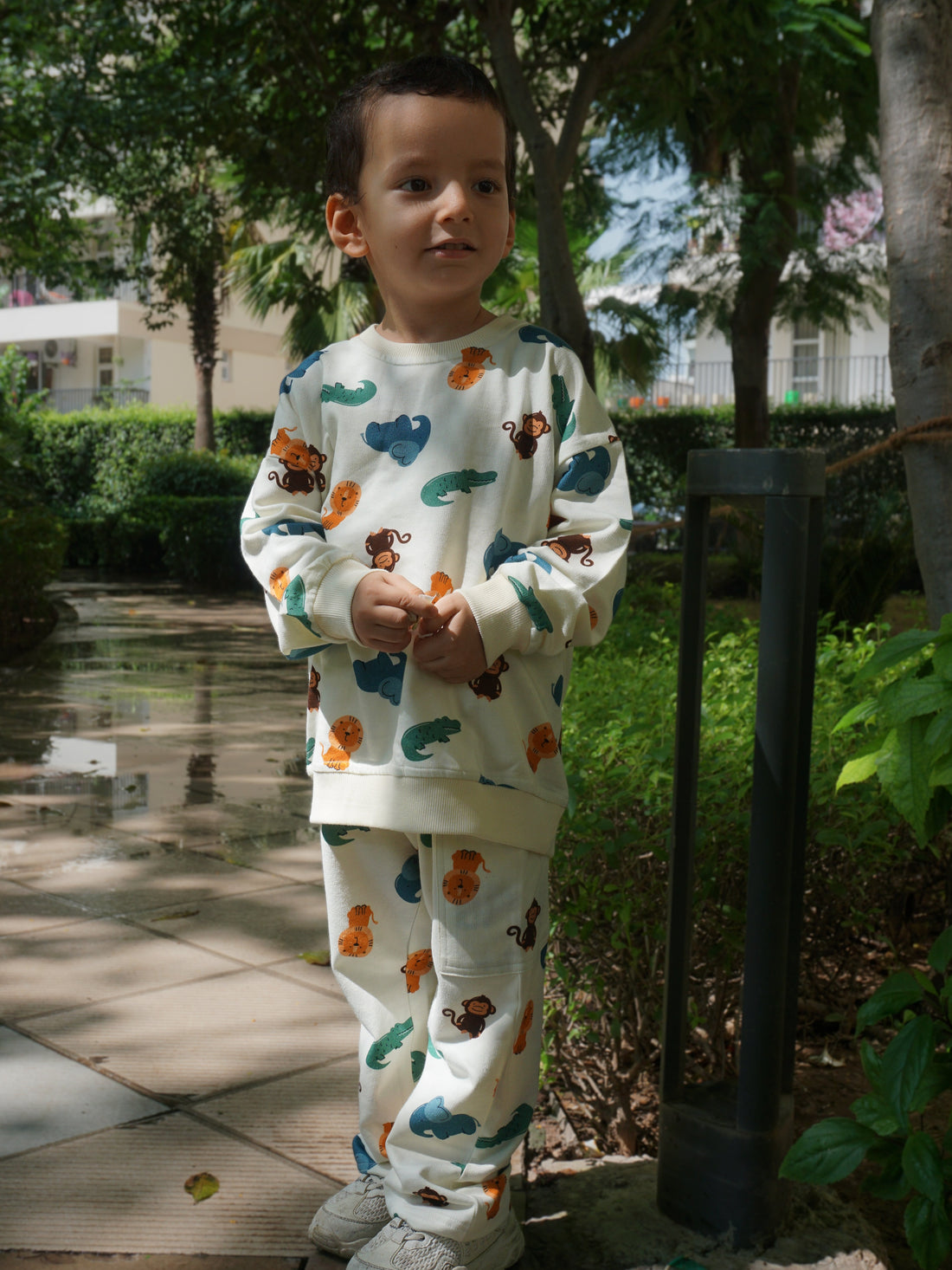 Child wearing the Gozi Jungle Friends oversized 100% cotton sweatshirt and jogger set for kids
